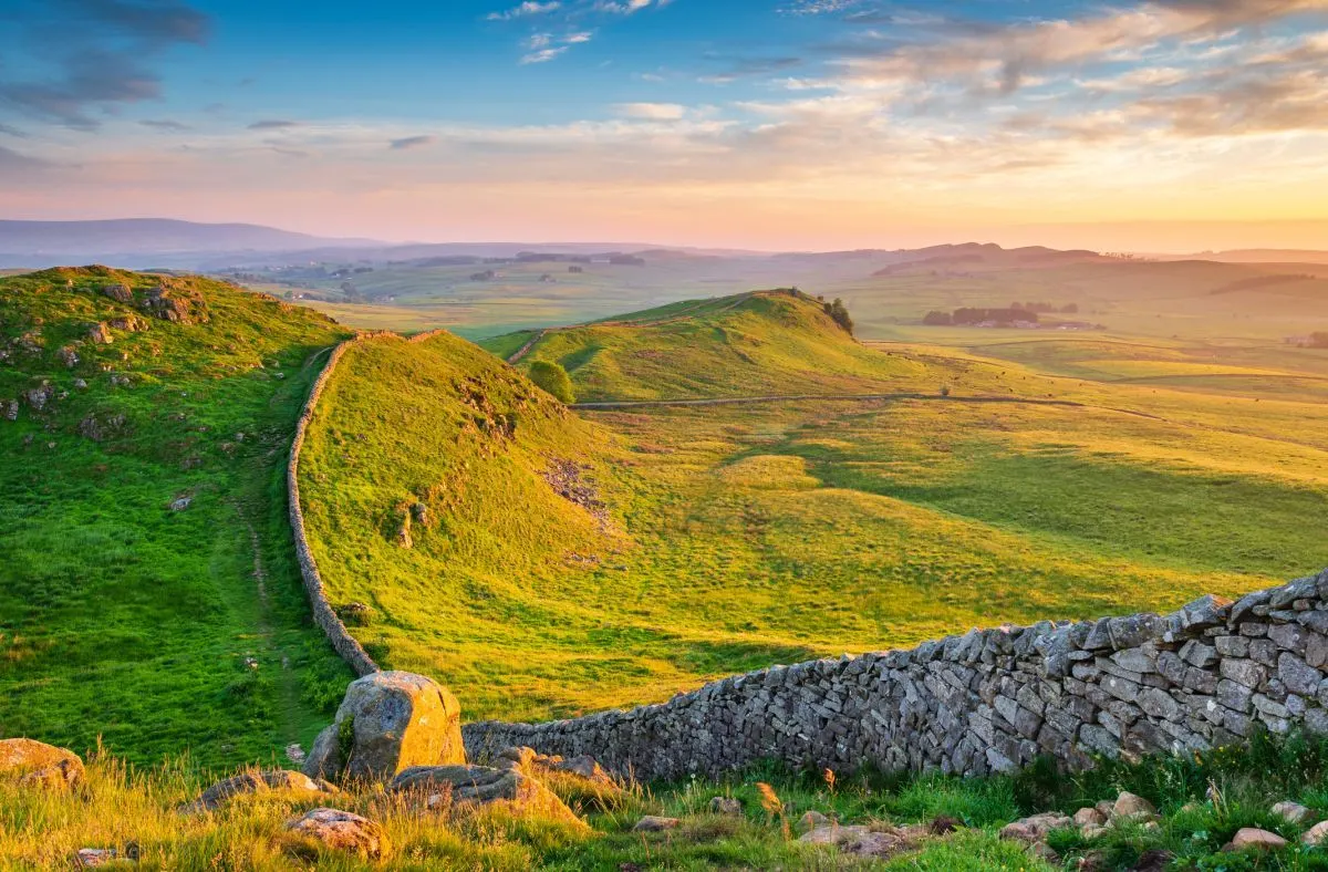 Hadrian's Wall running over the crags at Caw Gap in golden evening light